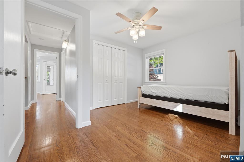 44 Alpine Place Kearny, NJ 07032 - Photo 35 of 50 a view of an empty room with wooden floor and a ceiling fan