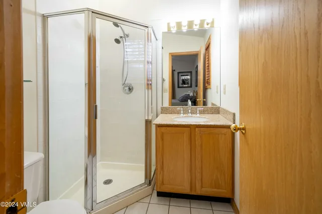 a bathroom with a shower and a sink