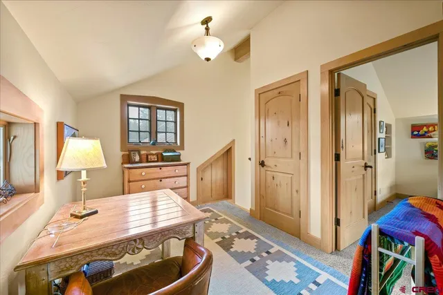 a living room with furniture and a dresser