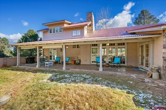 a view of a house with backyard porch and sitting area