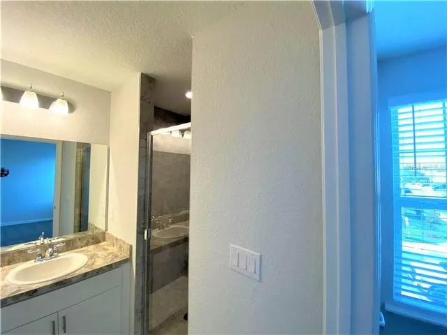 an empty room with a ceiling fan and a window