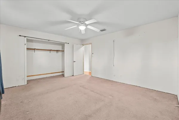 a view of a house with a big yard and large trees