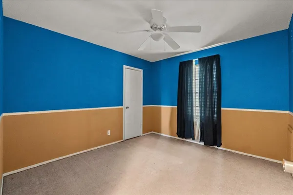 a front view of a house with a garden and trees