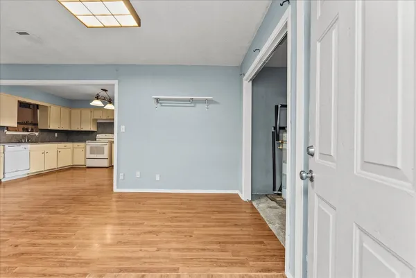 a big room with wooden floor and windows