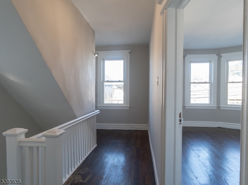 134 Maple Avenue Irvington, NJ 07111 - Photo 15 of 29 a view of a hallway with wooden floor and stairs