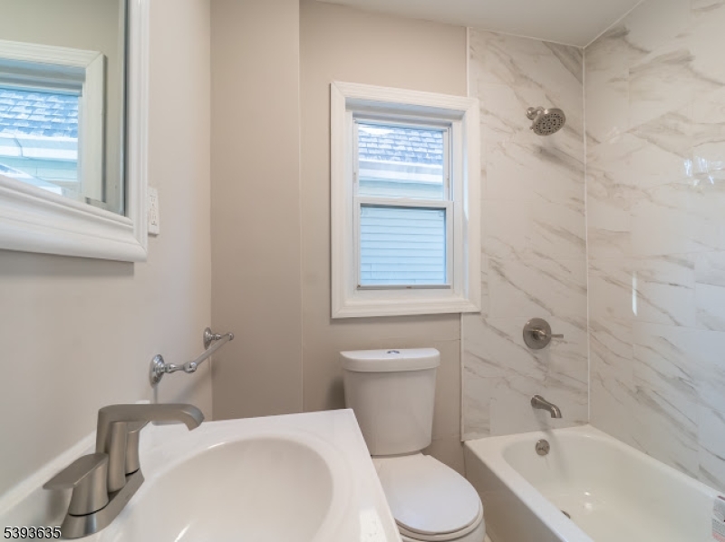 134 Maple Avenue Irvington, NJ 07111 - Photo 18 of 29 a bathroom with a sink toilet and shower