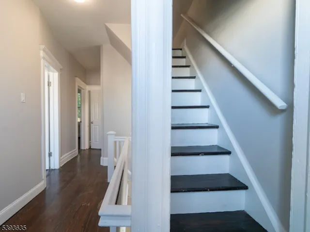 a view of entryway with wooden floor and stairs