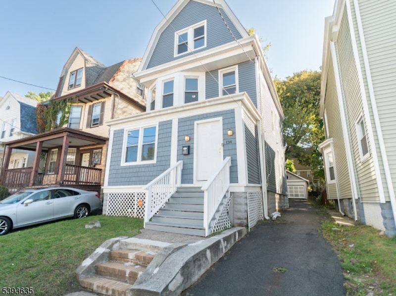 134 Maple Avenue Irvington, NJ 07111 - Photo 2 of 29 a front view of a house with a yard