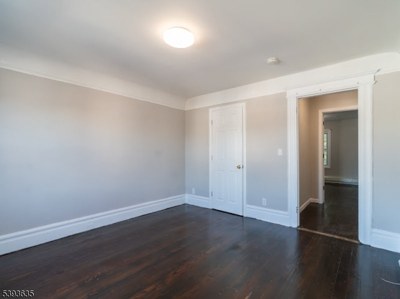 134 Maple Avenue Irvington, NJ 07111 - Photo 22 of 29 a view of wooden floor and windows in a room