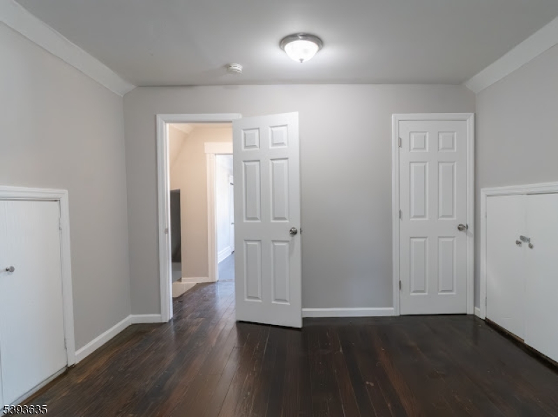 134 Maple Avenue Irvington, NJ 07111 - Photo 25 of 29 an empty room with wooden floor & closet area