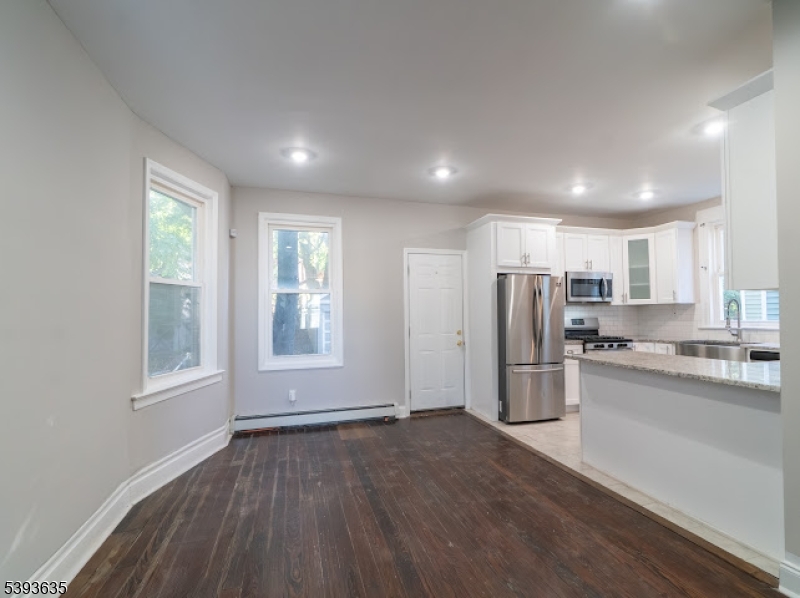 134 Maple Avenue Irvington, NJ 07111 - Photo 8 of 29 a view of kitchen with refrigerator and wooden floor