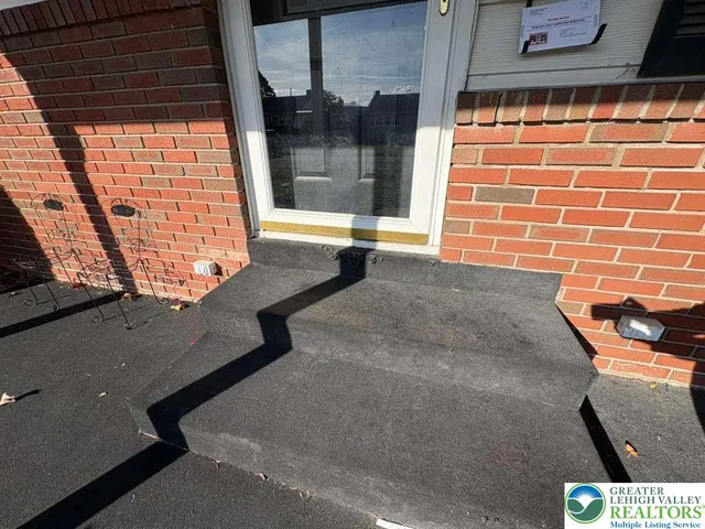 a kitchen with stainless steel appliances granite countertop a stove a refrigerator and a white cabinets