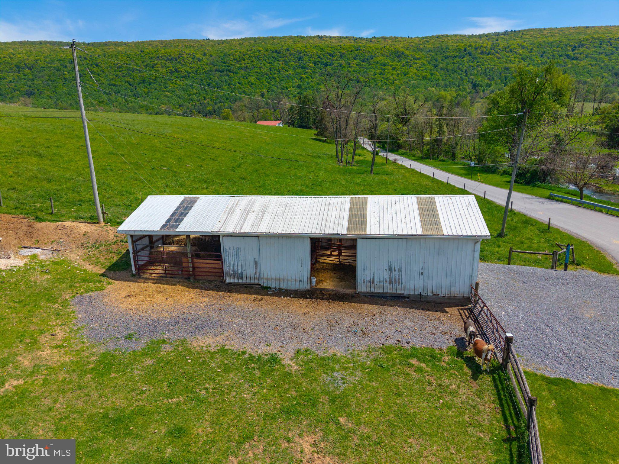 340 Applehouse Road Belleville, PA 17004 - Photo 12 of 76 Charming barn amidst lush green hills.