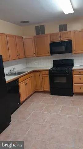 a kitchen with stainless steel appliances granite countertop a stove and a sink