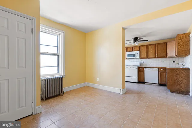 a view of a kitchen with a sink cabinet and a window