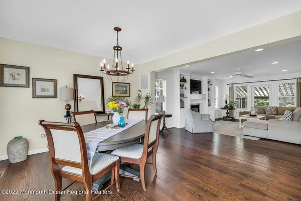 a view of a dining room with furniture wooden floor and chandelier