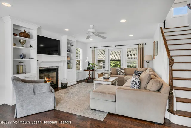 a living room with furniture fireplace and flat screen tv