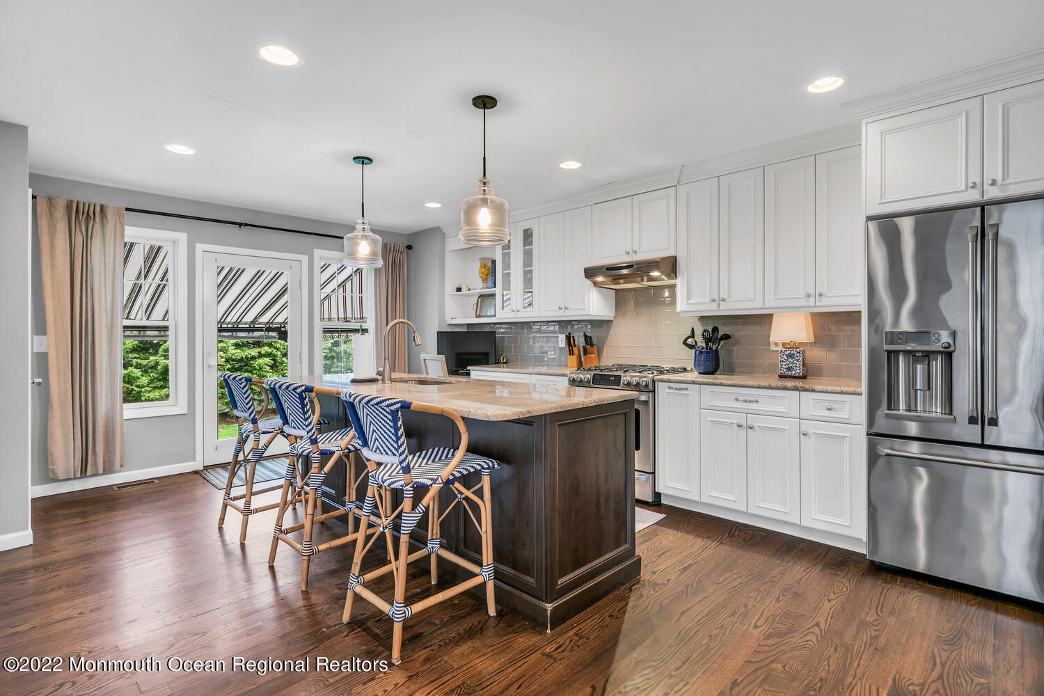 814 Pitney Drive Spring Lake Heights, NJ 07762 - Photo 8 of 22 a kitchen with stainless steel appliances granite countertop a stove a refrigerator a sink a dining table and chairs with wooden floor