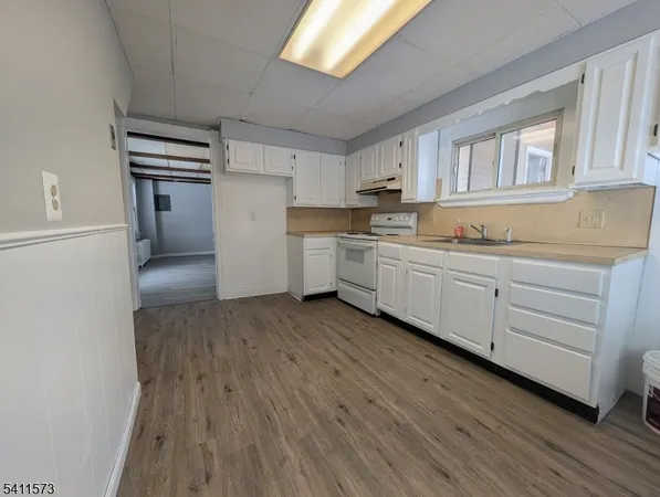 a kitchen with sink and cabinets