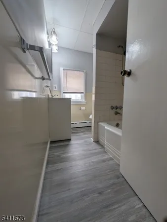 a view of a room with wooden floor