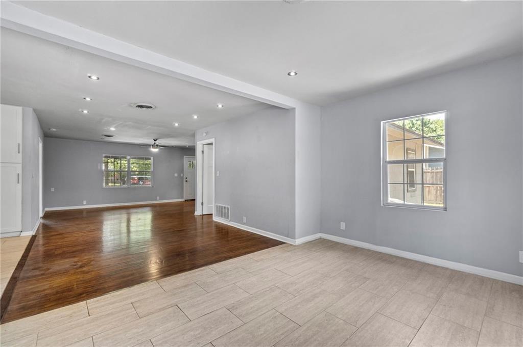 2105 Fortview Road Austin, TX 78704 - Photo 17 of 37 Recessed lighting illuminates warm hardwood and light tile flooring in this inviting open-plan interior.