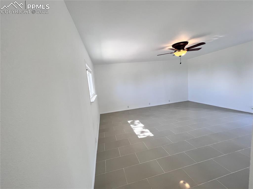 10199 Singer Lane Rye, CO 81069 - Photo 22 of 39 a view of an empty room with a ceiling fan and a window