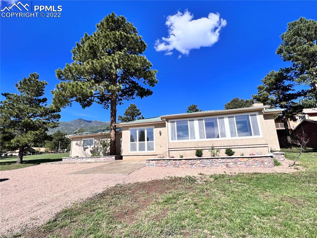 10199 Singer Lane Rye, CO 81069 - Photo 3 of 39 a front view of a house with a yard street and trees