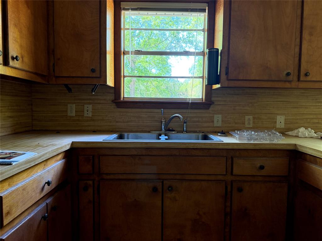 336 Butler Street Rusk, TX 75785 - Photo 15 of 27 a kitchen with a sink cabinets and window