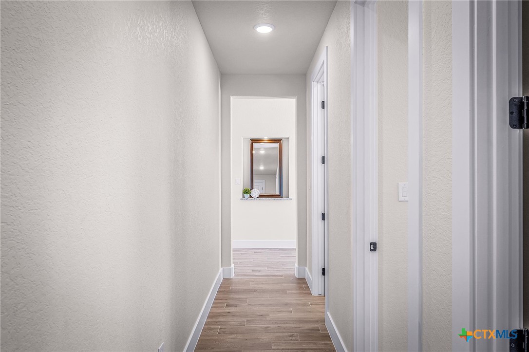 319 Serenity Pass Spring Branch, TX 78070 - Photo 11 of 26 a view of a hallway with wooden floor