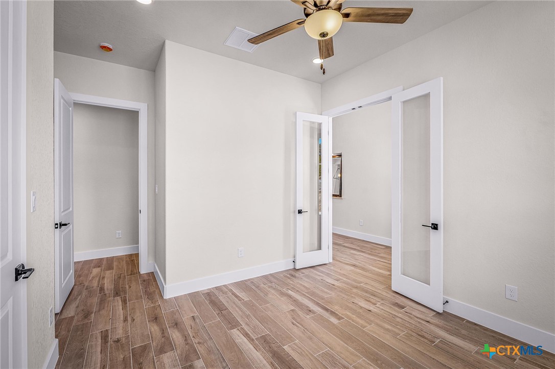 319 Serenity Pass Spring Branch, TX 78070 - Photo 6 of 26 wooden floor in an empty room with a window