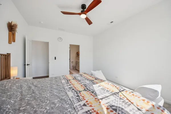 a bedroom with a bed and a chandelier