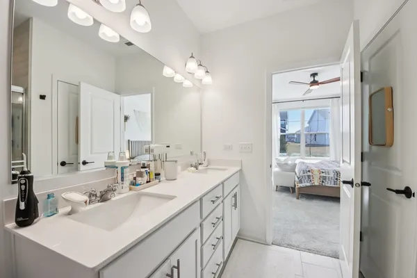 a bathroom with a sink double vanity and a mirror