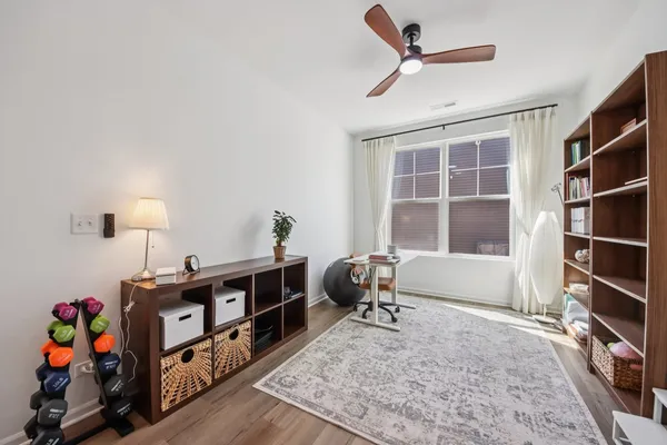 a living room with furniture cabinets and wooden floor