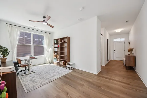 a view of a livingroom with workspace and a window