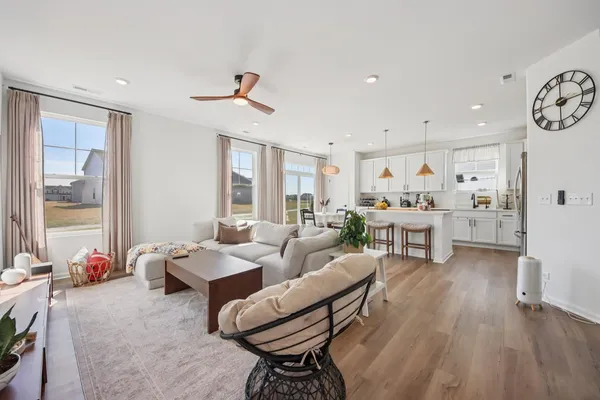 a living room with furniture and wooden floor