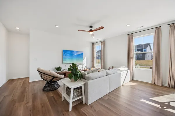 a living room with furniture and wooden floor