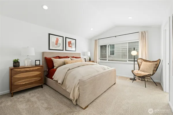 a spacious bedroom with a bed and a chair