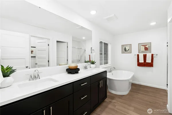 a bathroom with a double vanity sink mirror and toilet