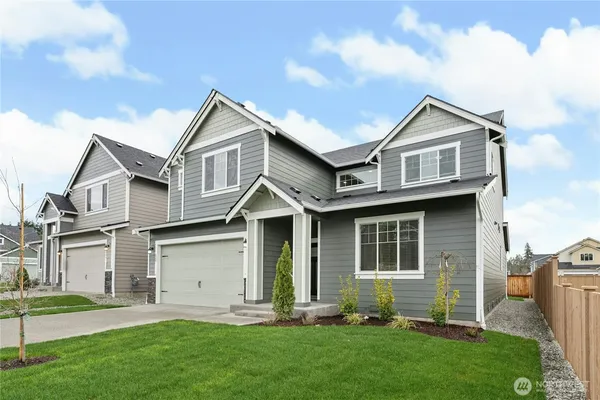 a front view of a house with a yard and porch