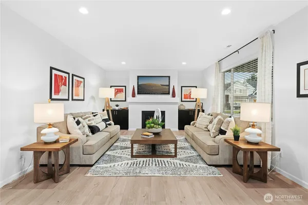 a living room with furniture a fireplace and a flat screen tv