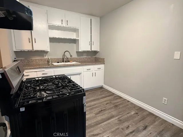 a kitchen with a sink stove and cabinets