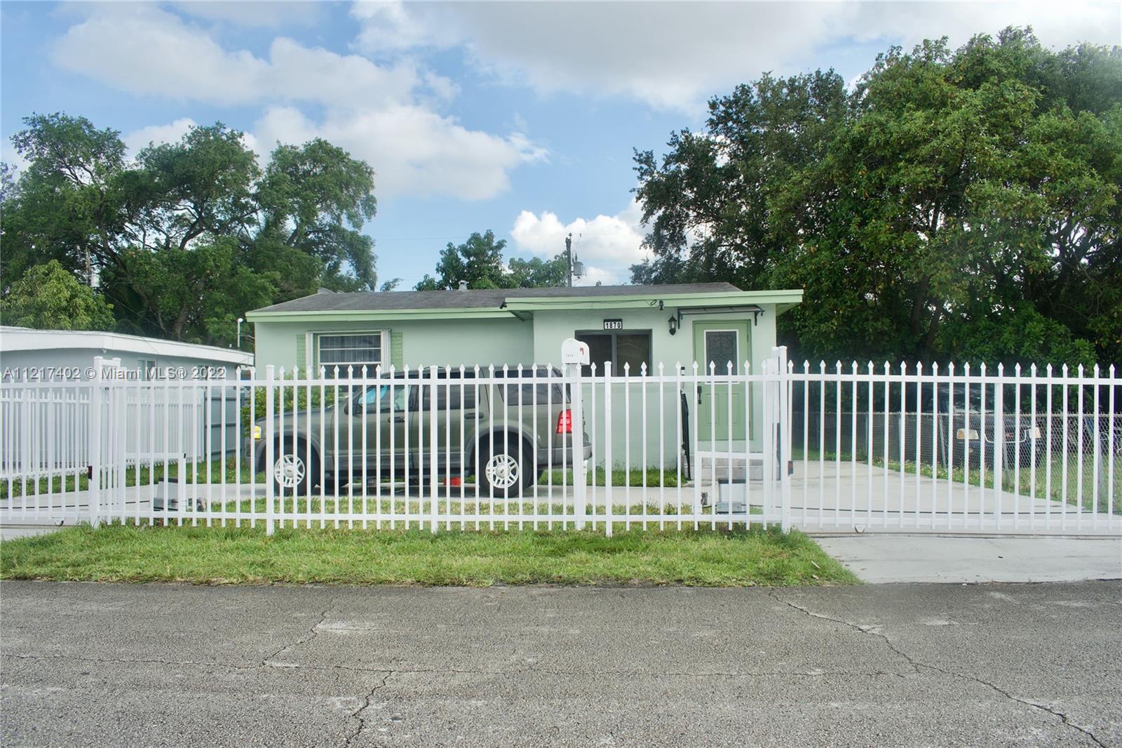 Westview Miami, FL 33167 - Photo 1 of 18 a view of a white house with a small garden