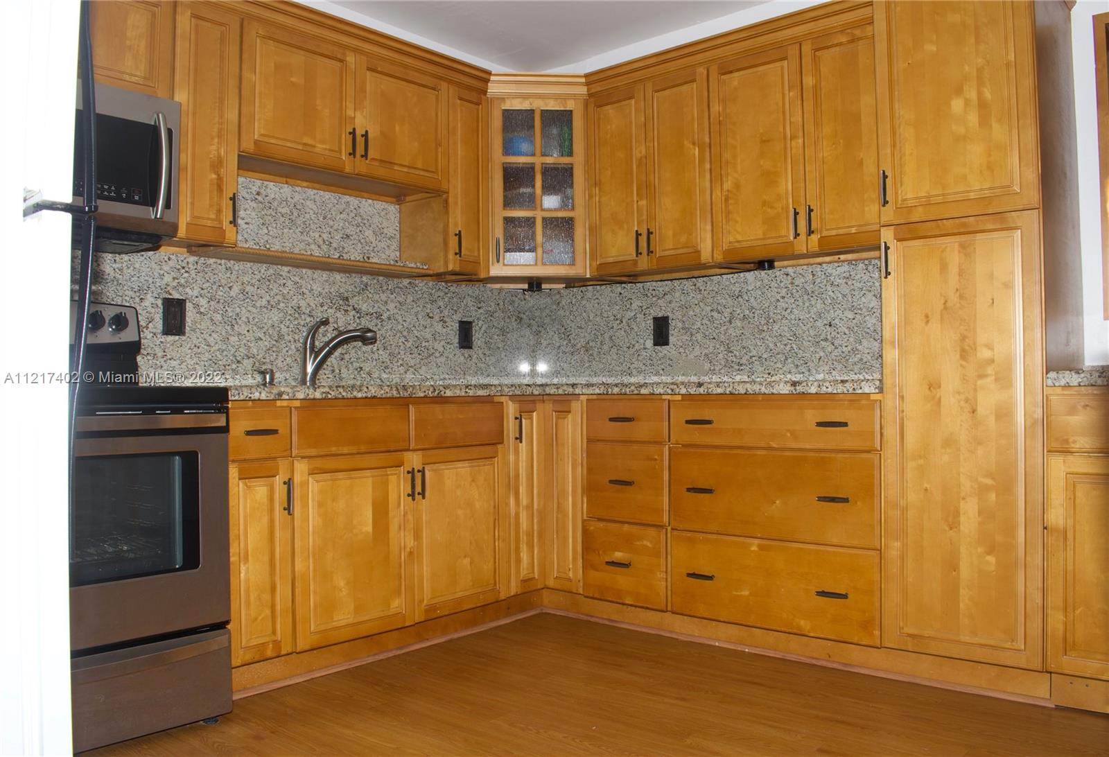 Westview Miami, FL 33167 - Photo 8 of 18 a kitchen with granite countertop cabinets stainless steel appliances and a counter space