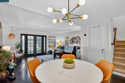 a living room with dining table furniture and a window