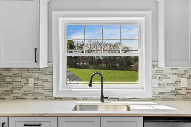 a bathroom with a sink and a window