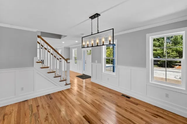 a view of an entryway with wooden floor and door