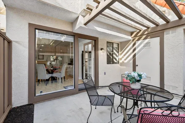 a dining room with furniture and a potted plant