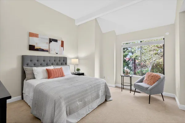 a bedroom with a bed chair and a window