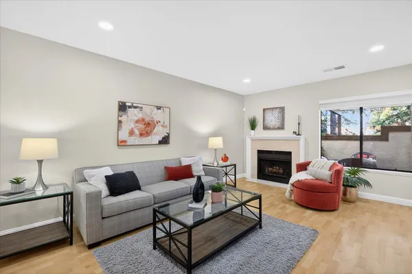 a living room with furniture a fireplace and a table