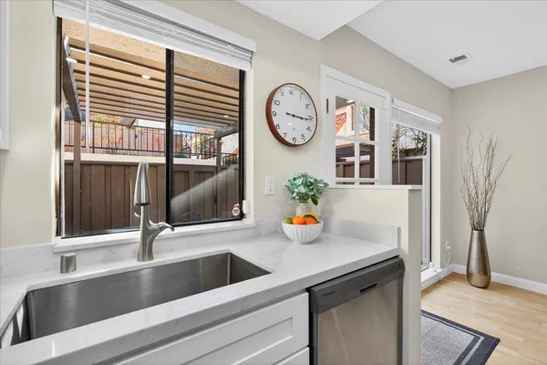 a kitchen with a sink and a stove top oven